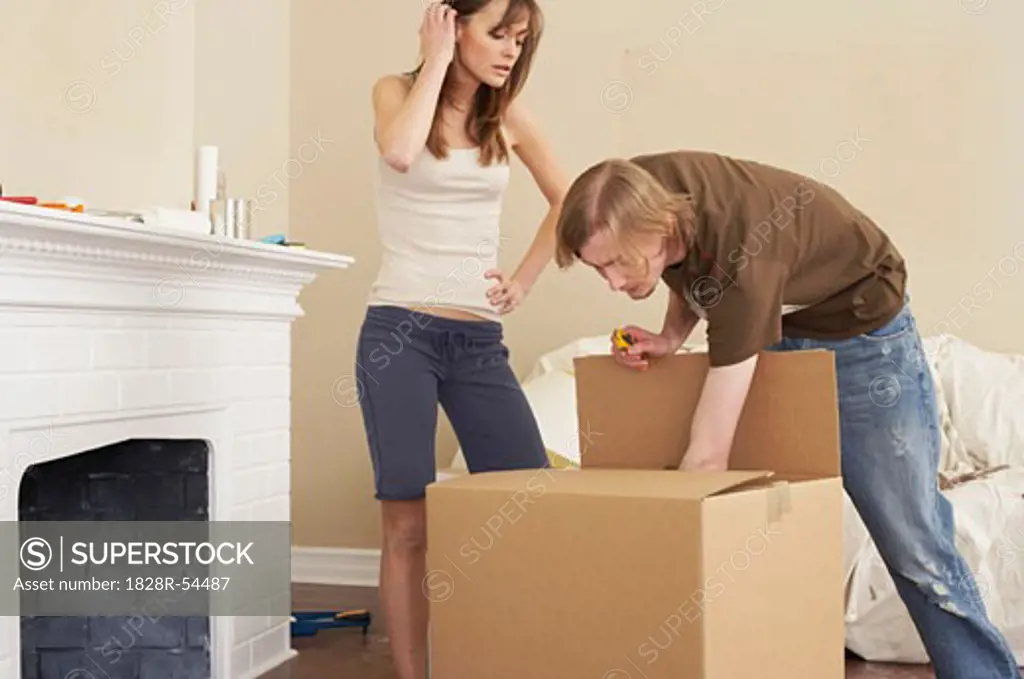 Couple Unpacking Boxes   