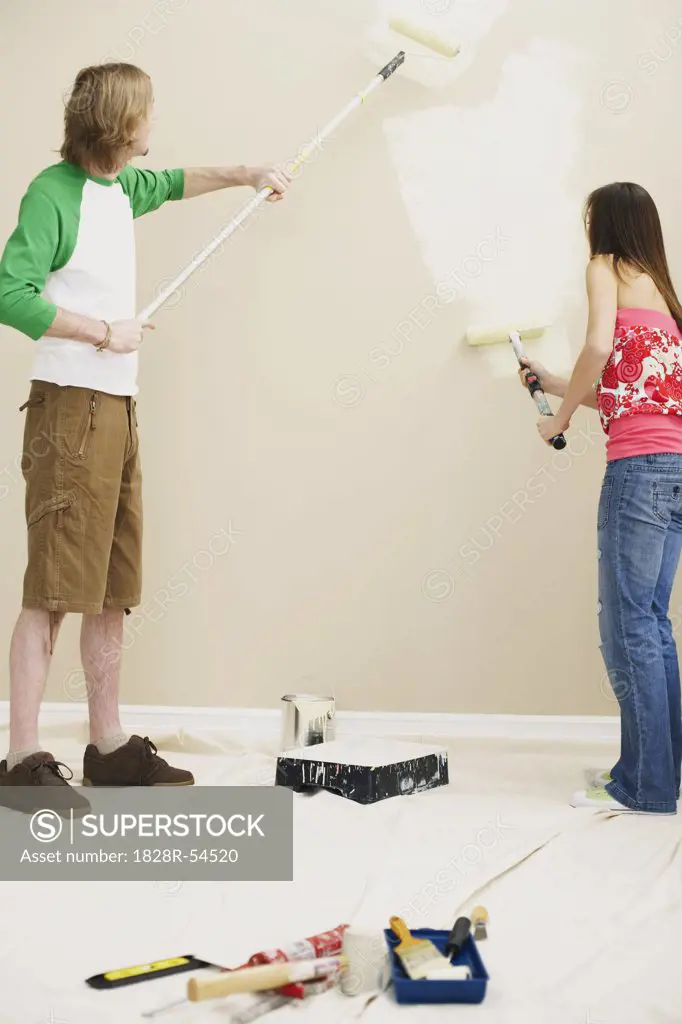 Couple Painting Home   