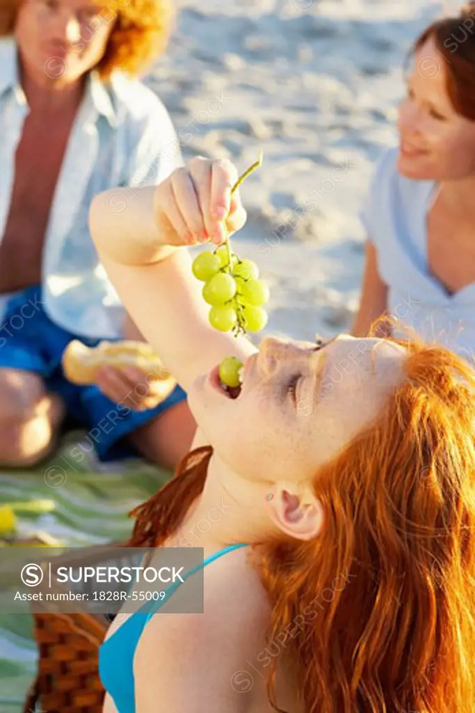 Girl Eating Grapes at Picnic   