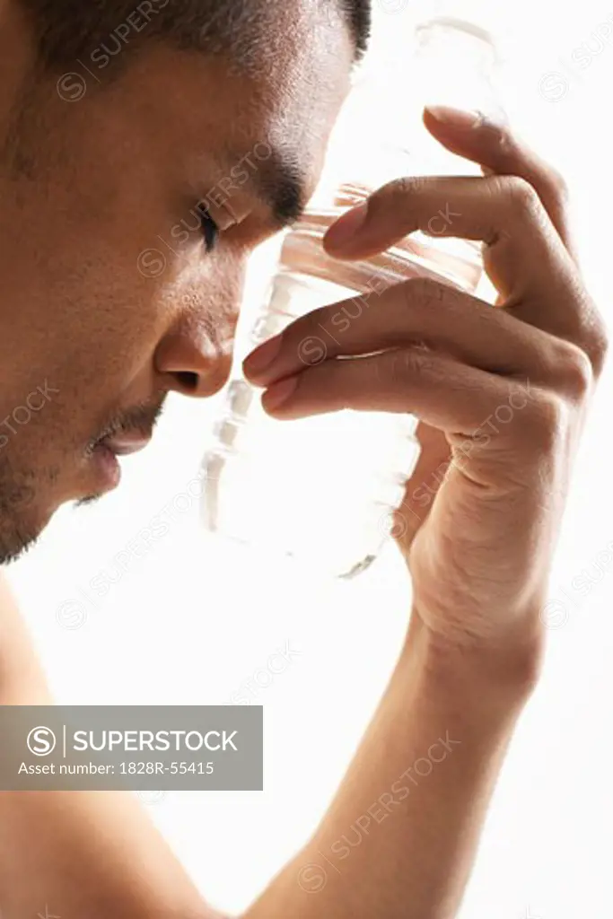 Man Cooling Off with Water Bottle   