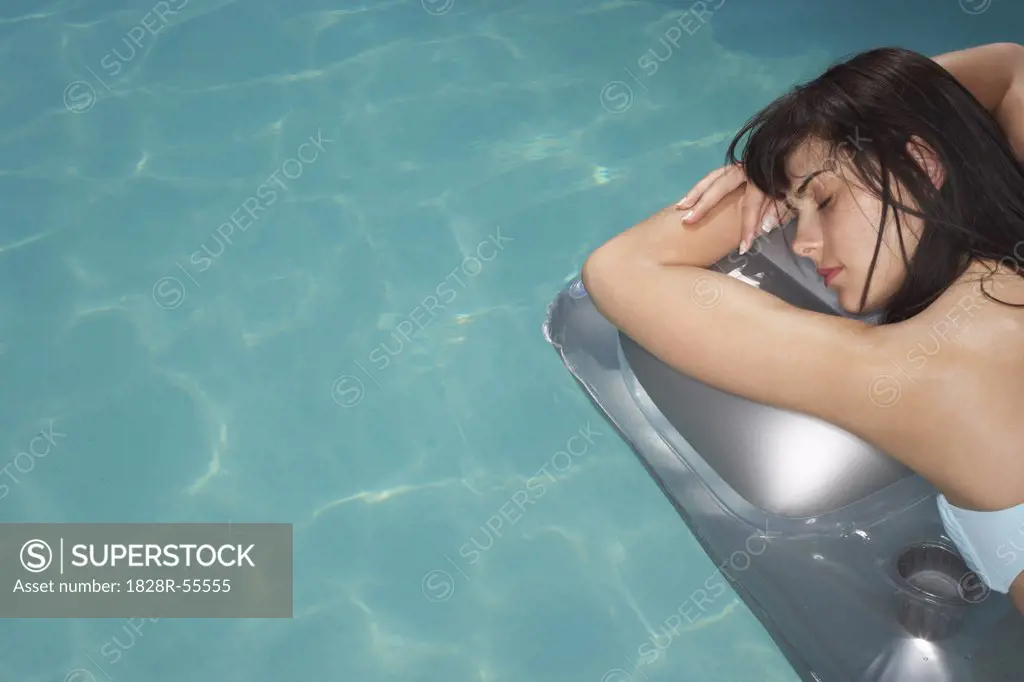 Woman Floating In Pool   