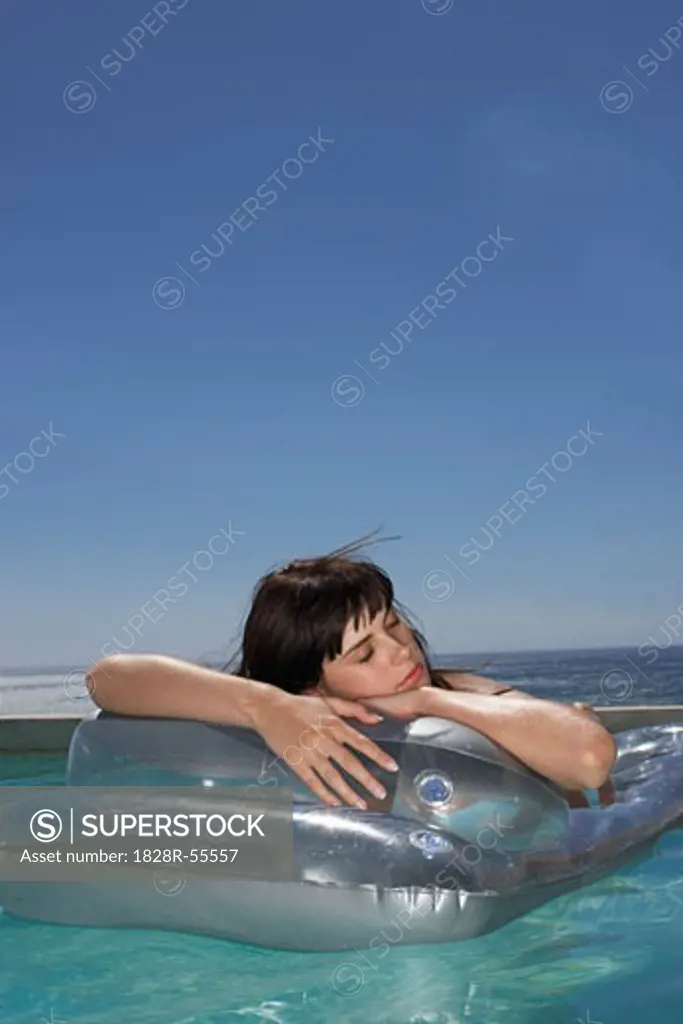 Woman Floating In Pool   