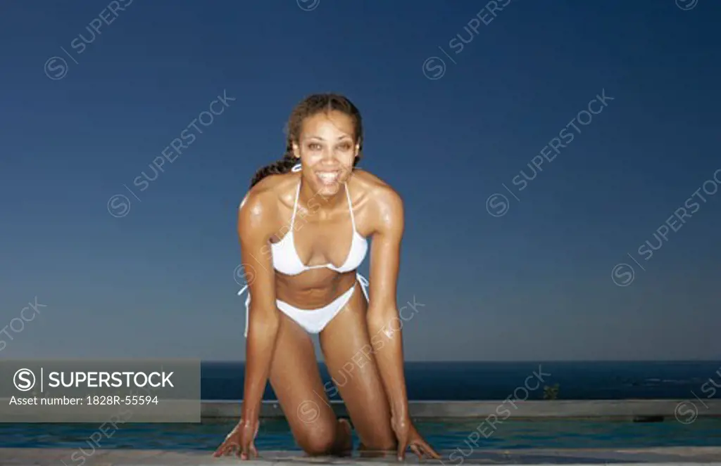 Woman Getting Out Of Swimming Pool   