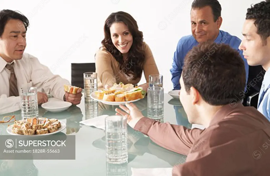 Business People with Snacks in Boardroom   
