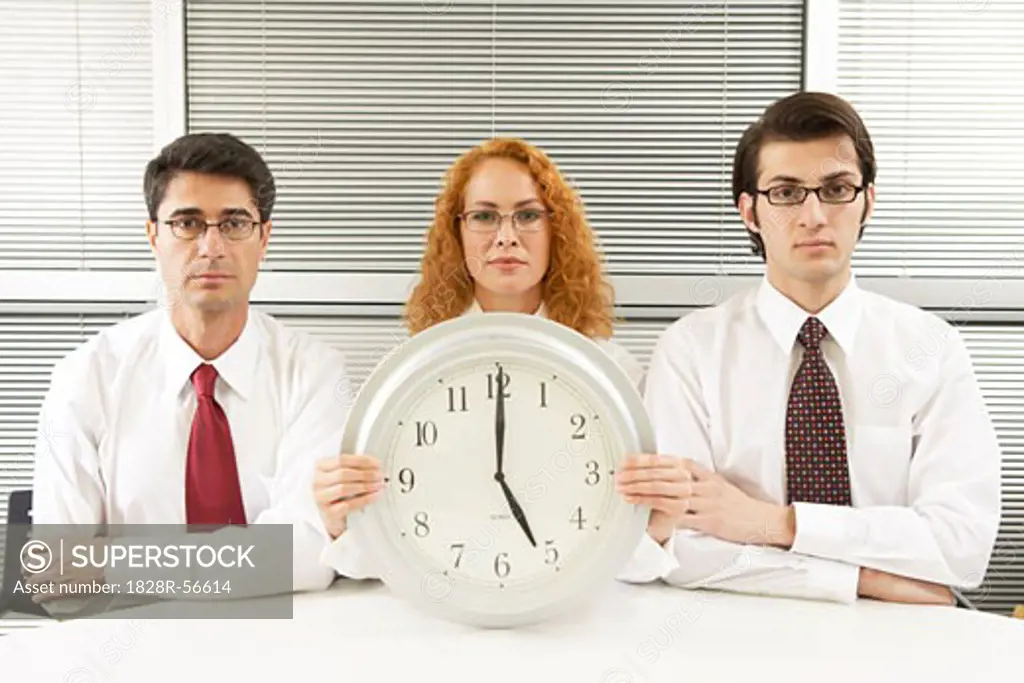 Portrait of Business People With Clock   