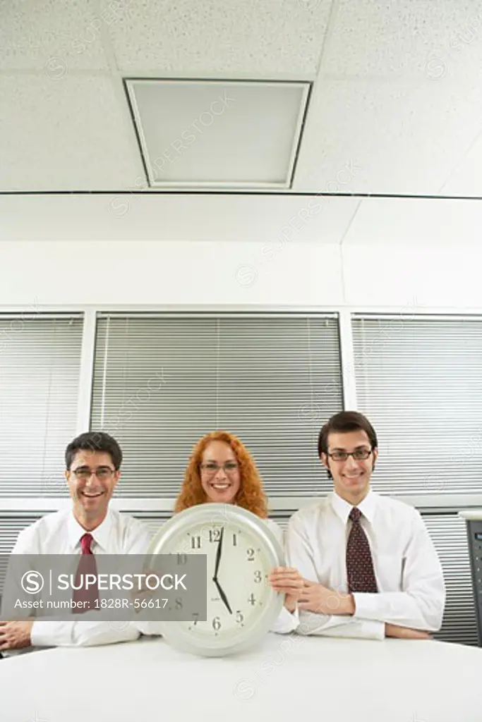 Portrait of Business People With Clock   