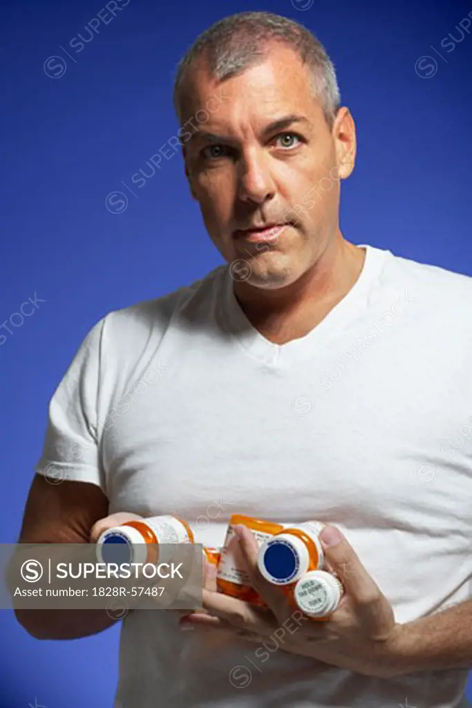Portrait of Man Holding Pill Bottles   