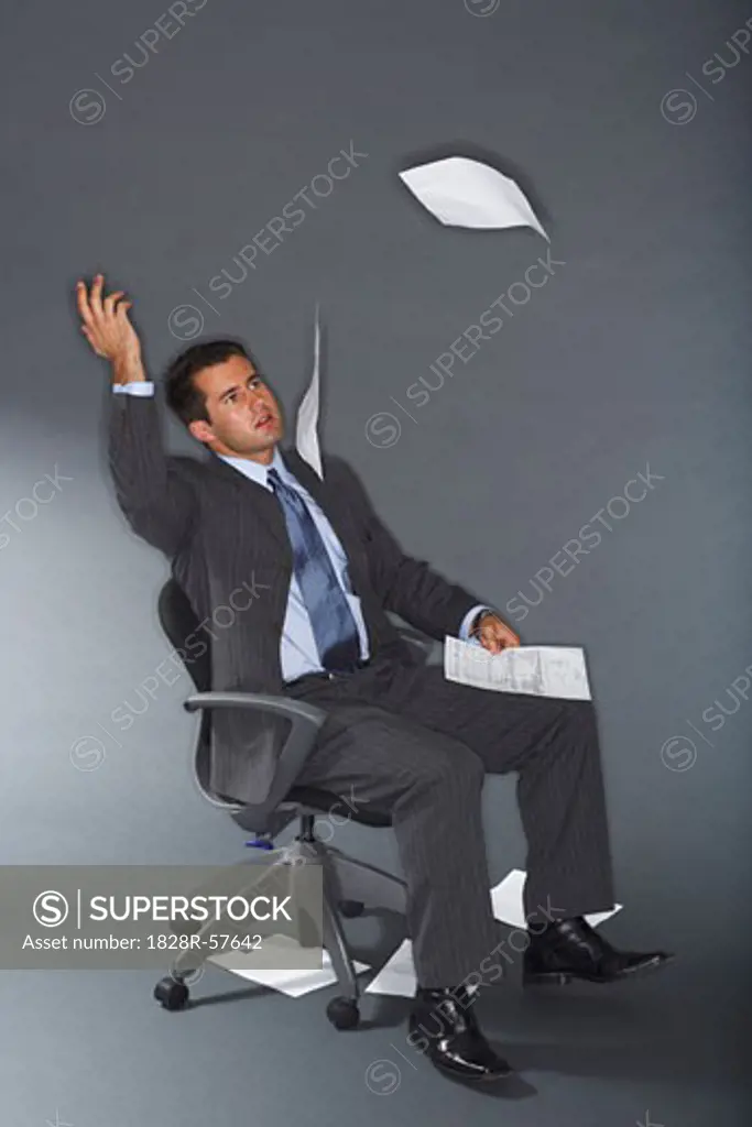 Frustrated Businessman Throwing Documents in Air   