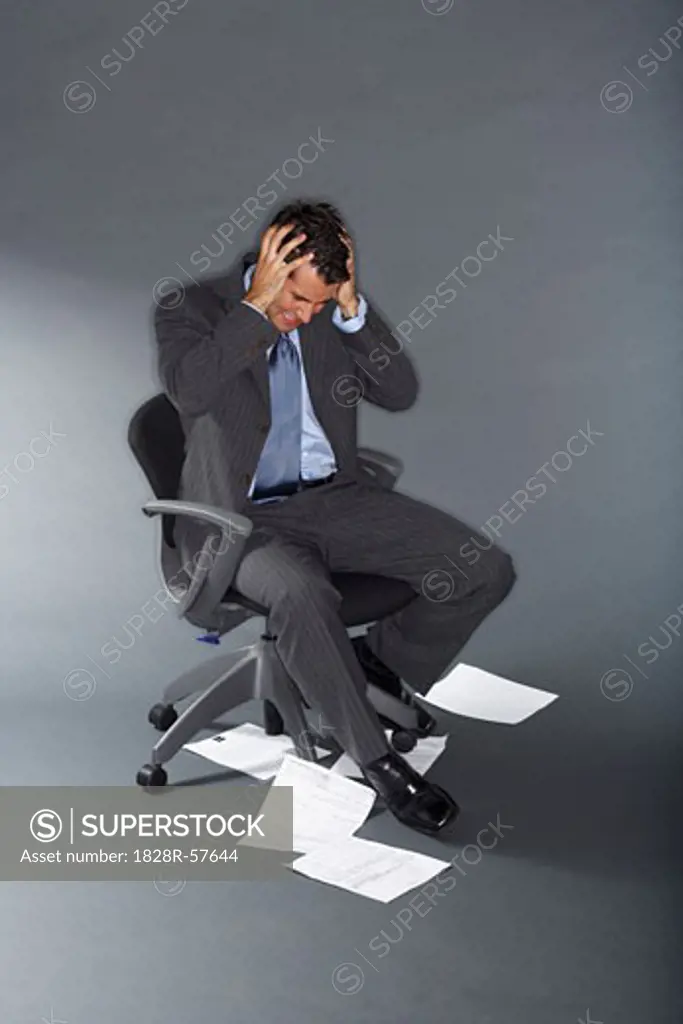 Frustrated Businessman With Documents on the Floor   