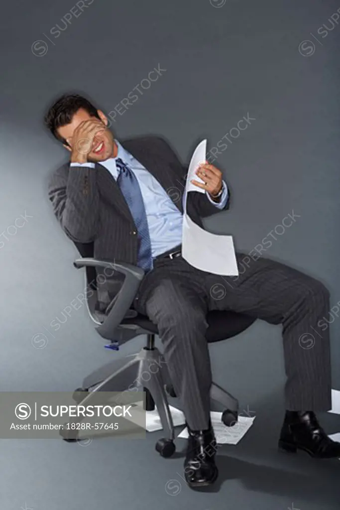 Frustrated Businessman Holding Documents   