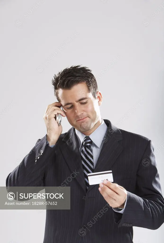 Man with Cellular Phone and Credit Card   