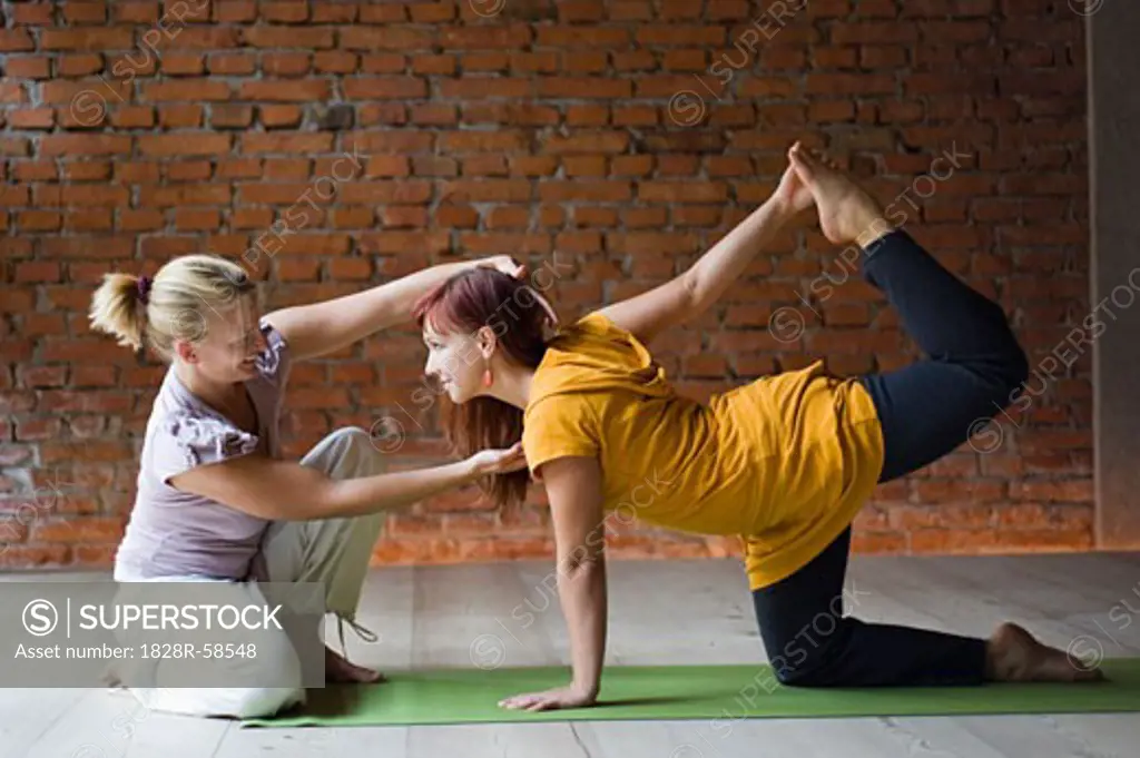 Yoga Teacher With Student, Doing Tiger Pose   