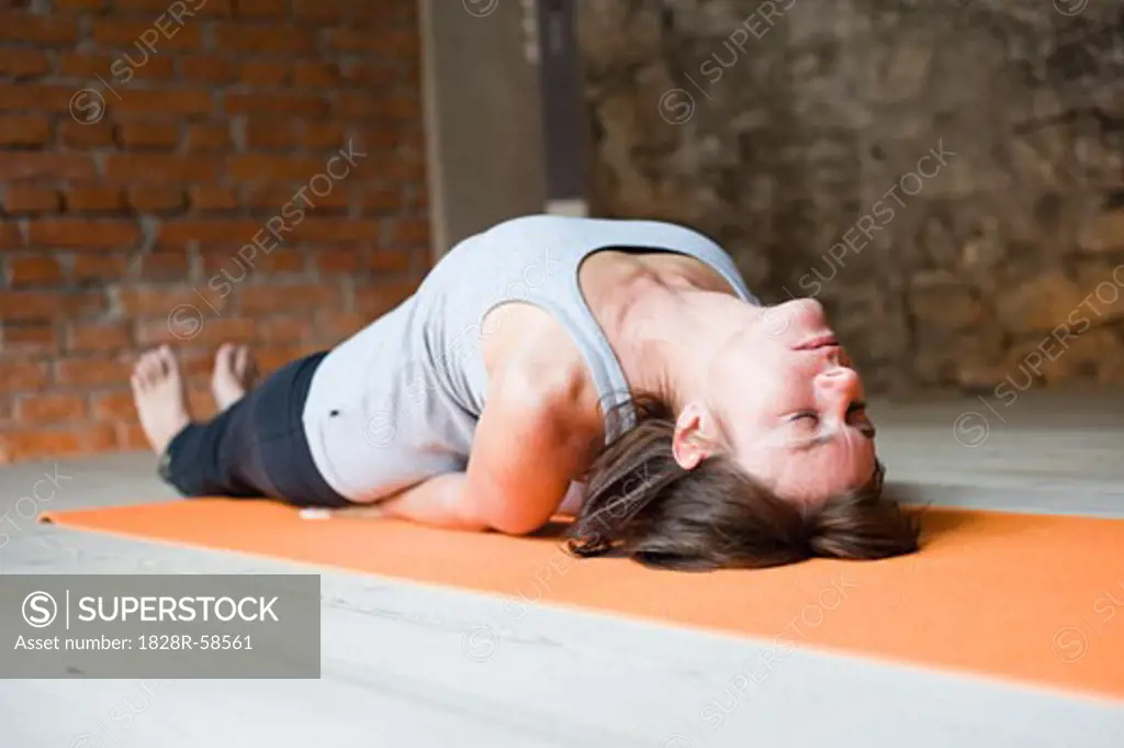 Woman in Yoga Class Doing Fish Pose   