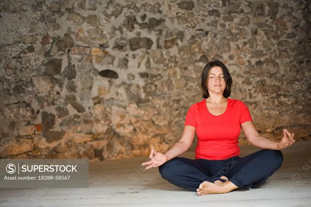 Woman in Yoga Class Meditating   
