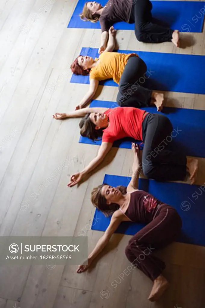 Women in Yoga Class Doing Spinal Twist   