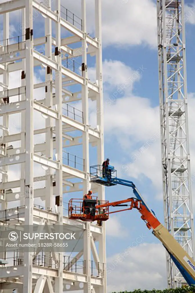 Construction Workers in Hydraulic Lifts   