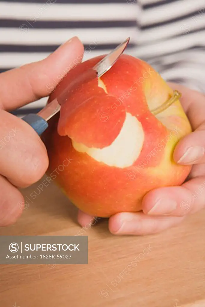 Hands Peeling Apple