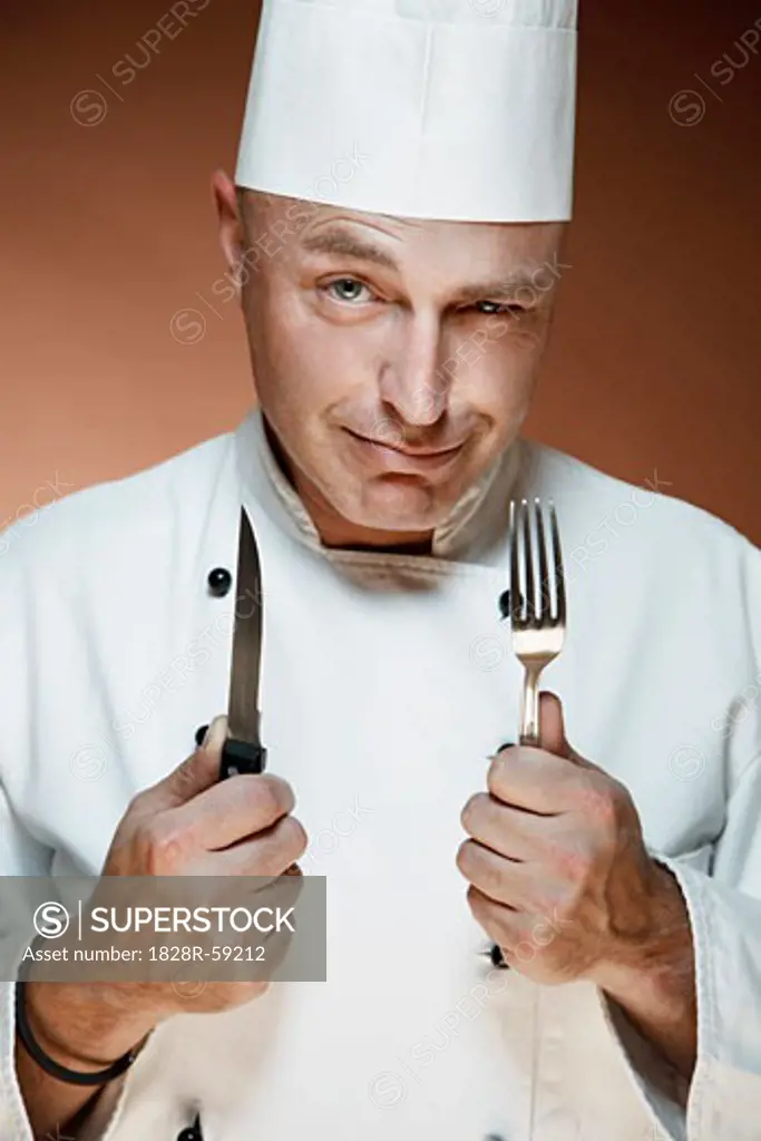 Portrait of Chef Holding Knife and Fork   