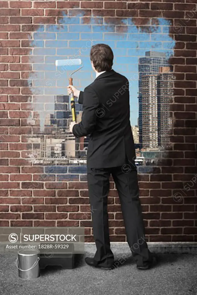 Businessman Painting Cityscape on Brick Wall   