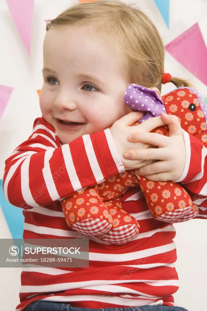 Little Girl Hugging Her Stuffed Animal   