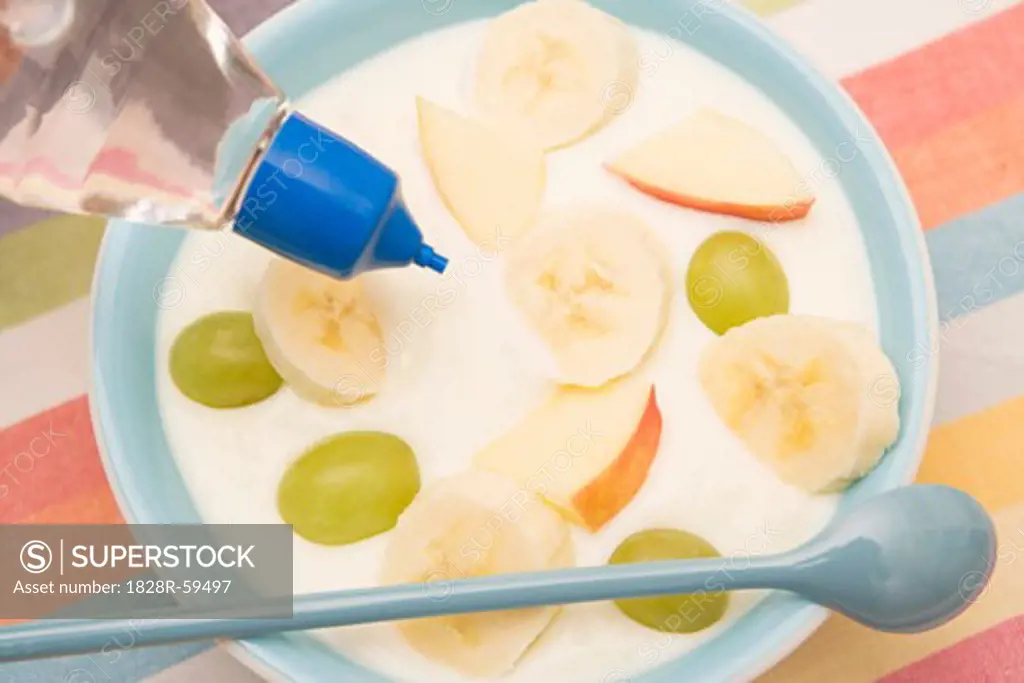 Putting Artifical Sweetener in Bowl of Fruit and Yogurt   