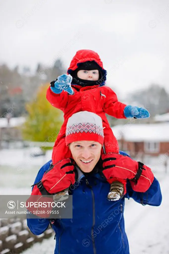 Little Boy Riding on Father's Shoulders in Winter, Portland, Oregon, USA