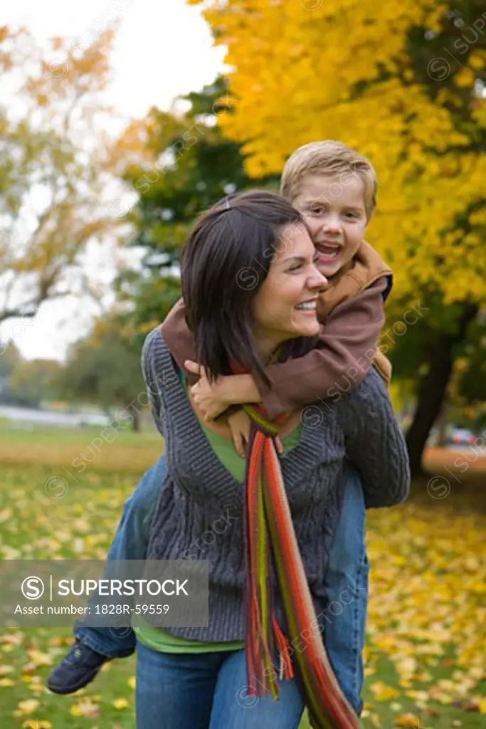 Little Boy Getting a Piggyback Ride From His Mother, Portland, Oregon, USA   