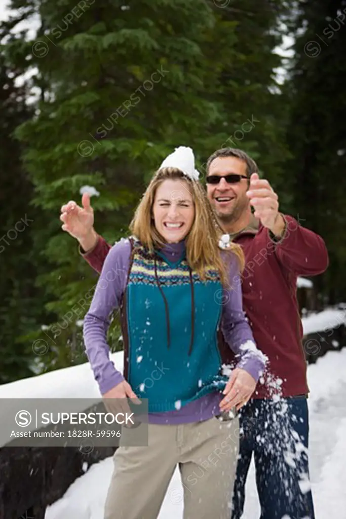 Man Dropping Snow on Wife's Head, Bend, Oregon, USA   