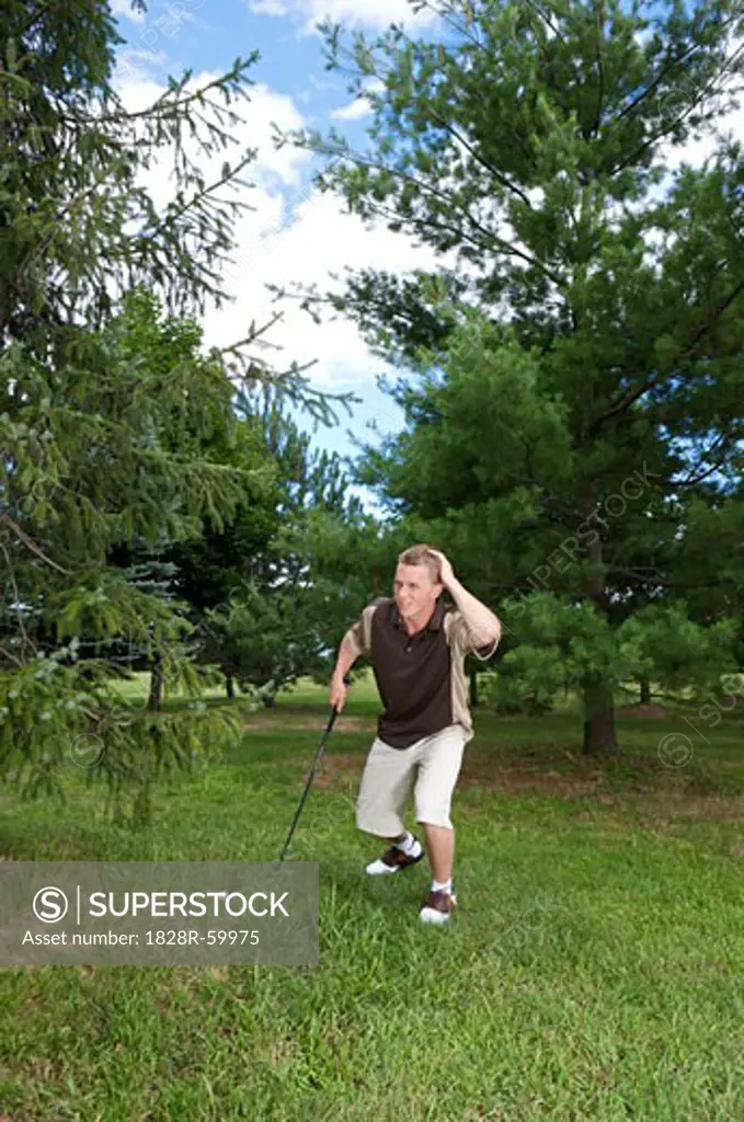 Golfer Looking for Ball in Rough, Burlington, Ontario, Canada   