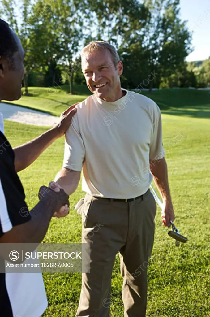 Friends Shaking Hands on Golf Course, Burlington, Ontario, Canada   