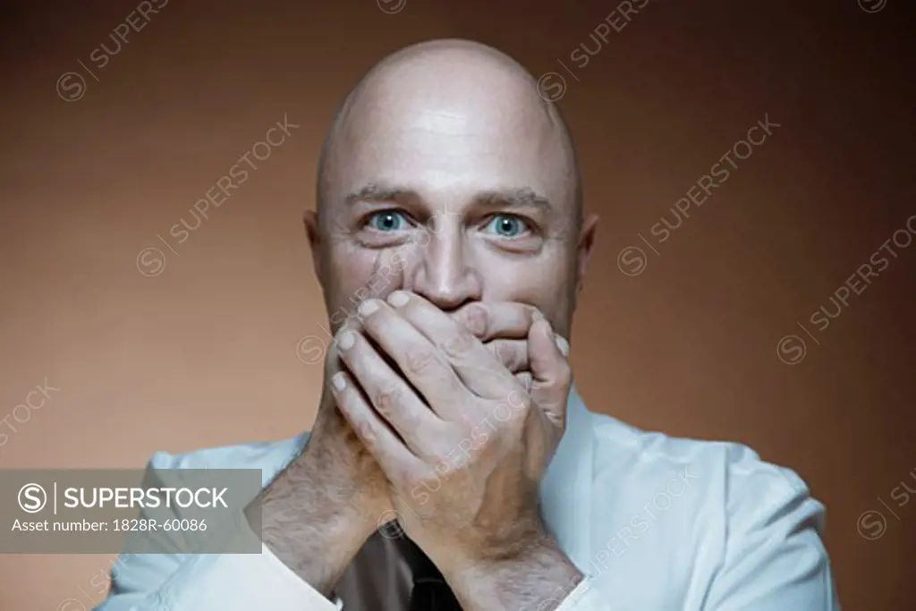 Portrait of Man Covering Mouth with Hands   