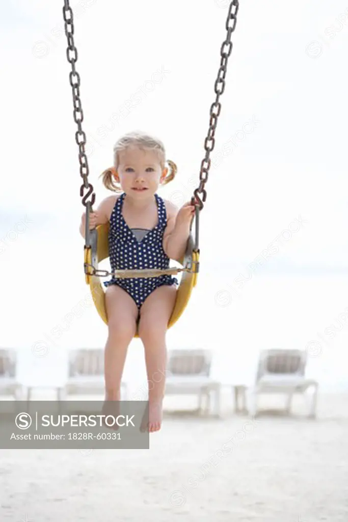 Girl Wearing Bathing Suit in Swing on Beach, Cancun, Mexico   