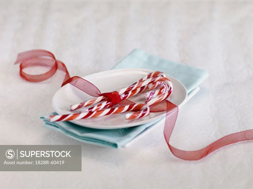 Candy Canes Tied with Red Ribbon on Plate   