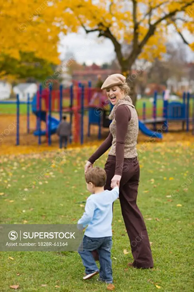 Mother and Son Walking in the Park in Autumn, Portland, Oregon, USA   