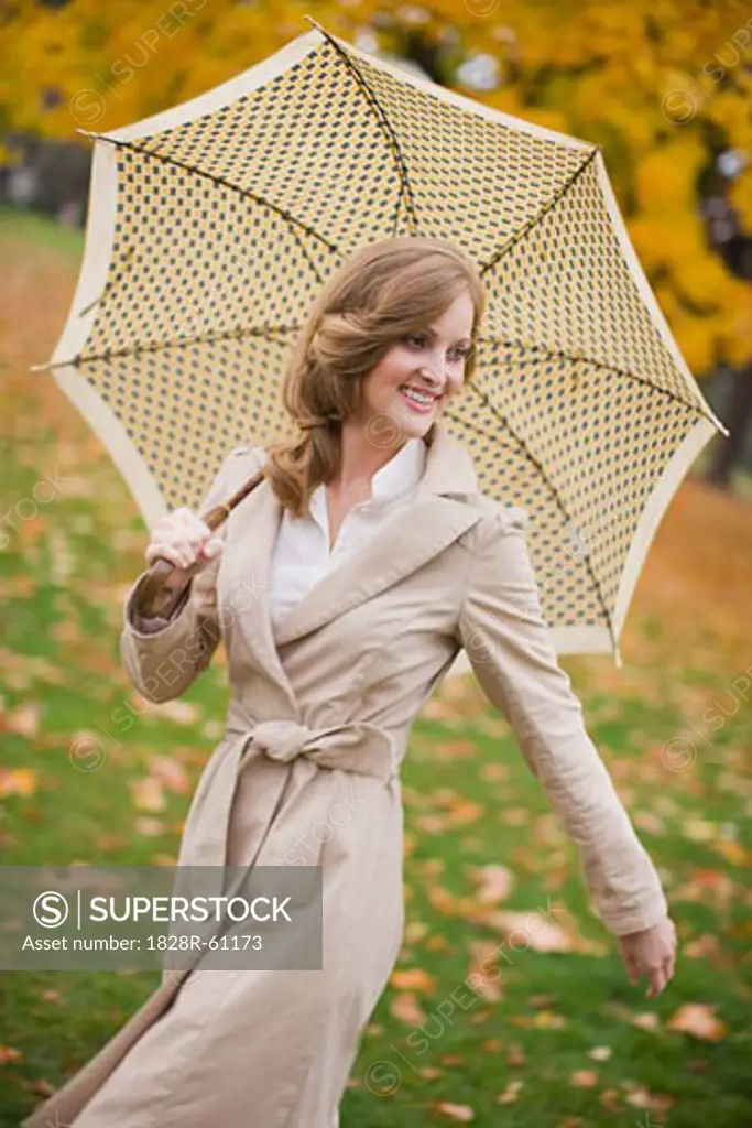 Woman With an Umbrella Walking in the Park, Portland, Oregon, USA   