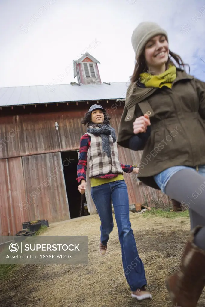 Two Teenage Girls Running on a Farm in Hillsboro, Oregon, USA   