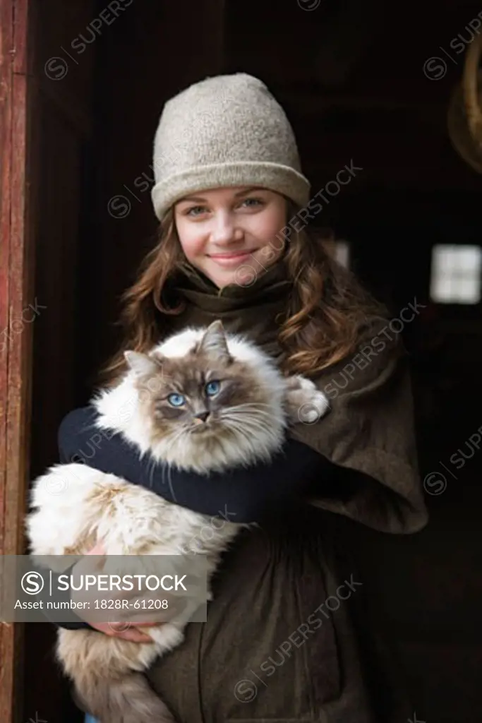 Portrait of a Teenage Girl Holding a Cat on a Farm in Hillsboro, Oregon, USA