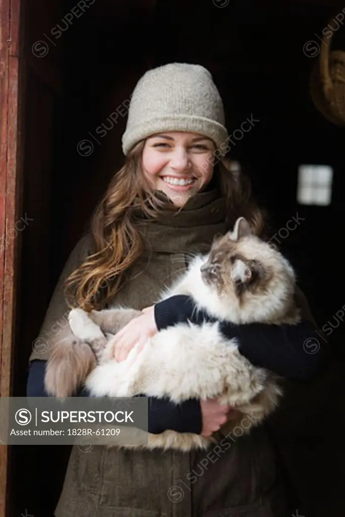Portrait of a Teenage Girl Holding a Cat on a Farm in Hillsboro, Oregon, USA   