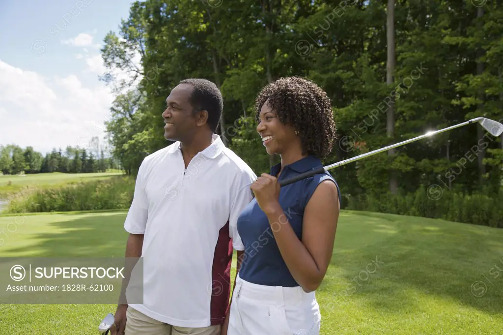 Couple holding Golf Clubs