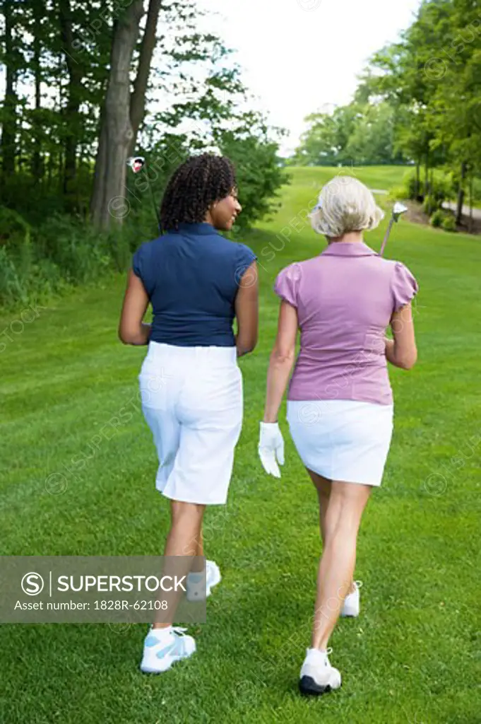 Back View of Women Walking on Golf Course