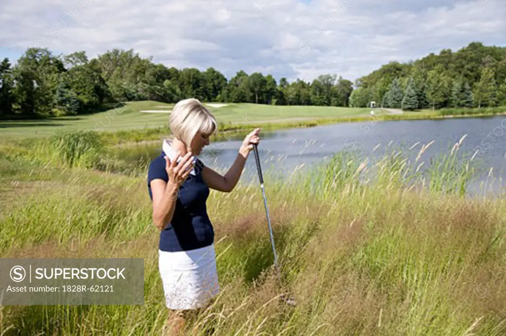 Golfer Searching for Ball in Tall Grass