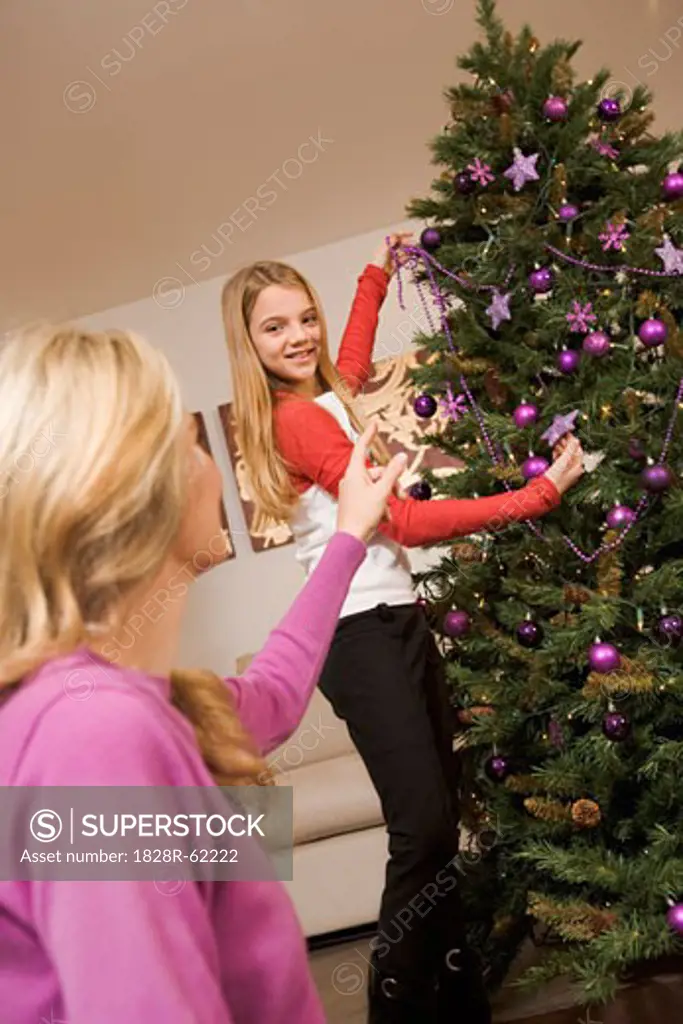 Mother and Daughter Decorating Christmas Tree   