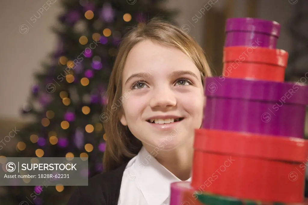 Girl with Stack of Christmas Gifts   