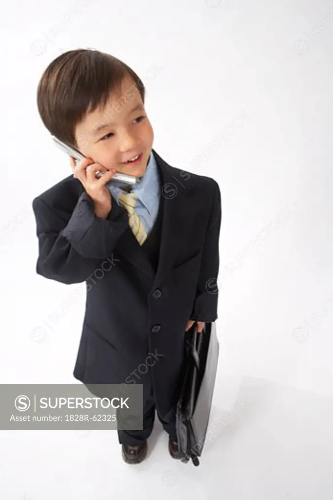 Little Boy Dressed Up as a Businessman Talking on Cell Phone