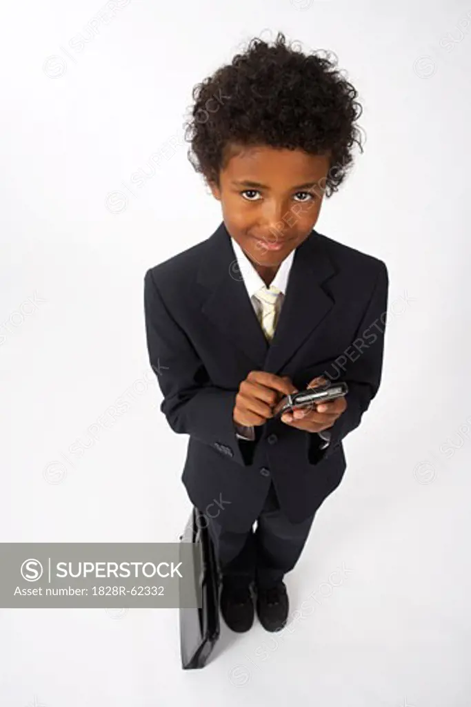 Little Boy Dressed Up as a Businessman Using Cell Phone