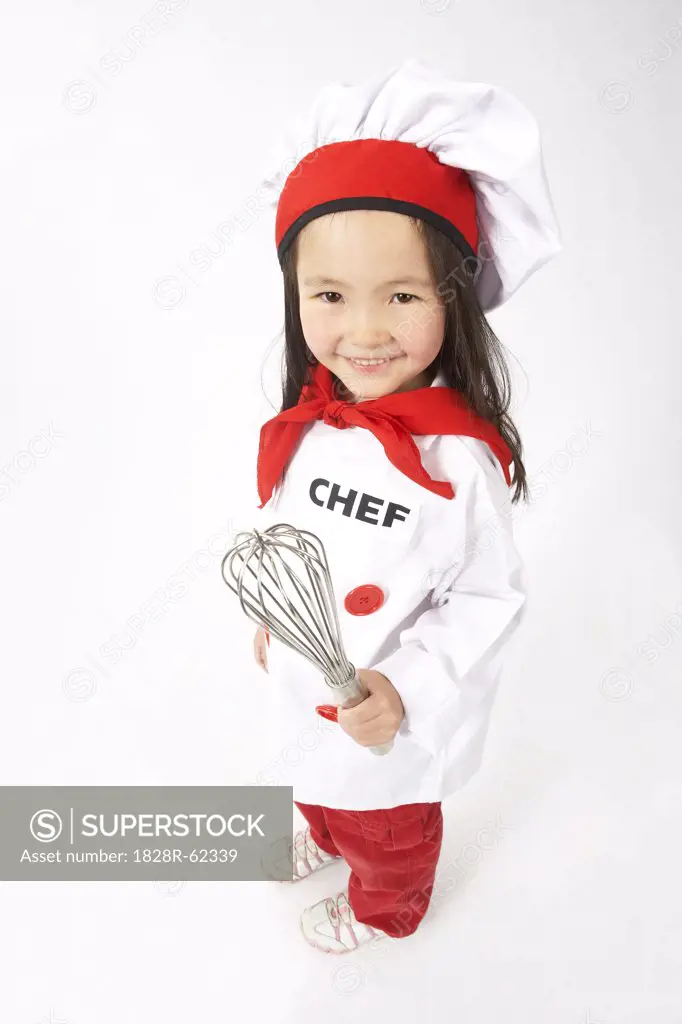 Little Girl Dressed Up as a Chef Holding a Whisk   