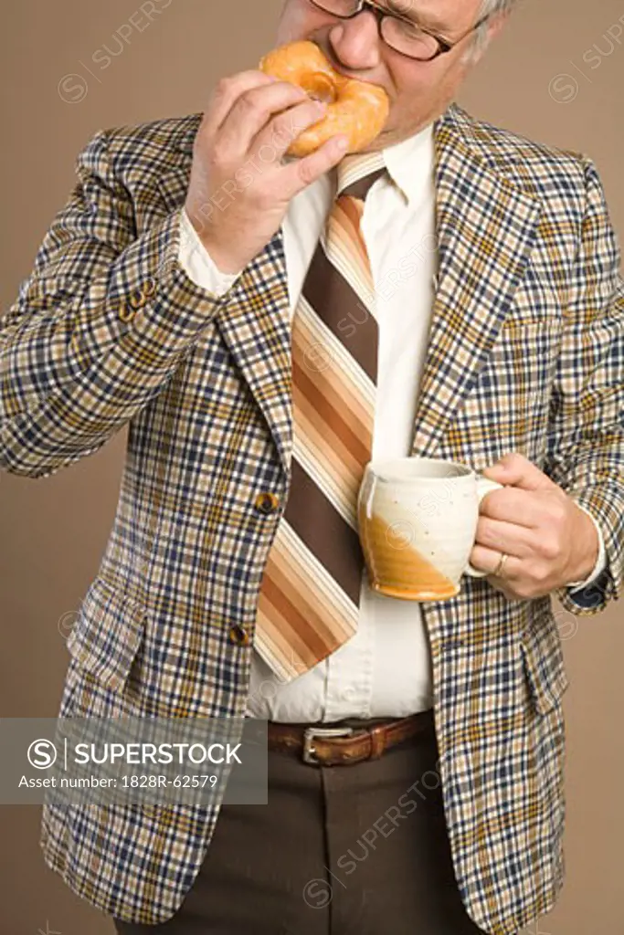Retro Businessman Eating a Doughnut and Drinking a Cup of Coffee