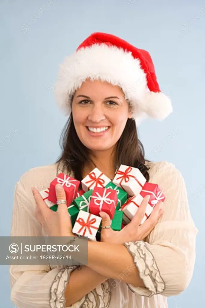 Woman Wearing Santa Hat and Holding Miniature Christmas Gifts