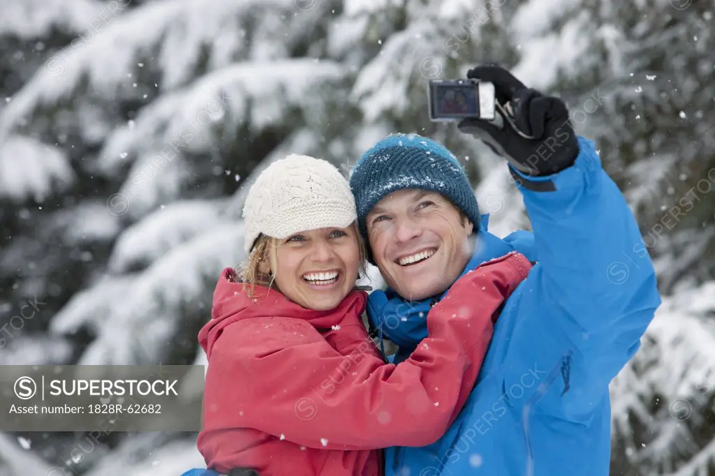 Couple Taking Self Portrait with Camera Phone Outdoors in Winter, Whistler, British Columbia, Canada