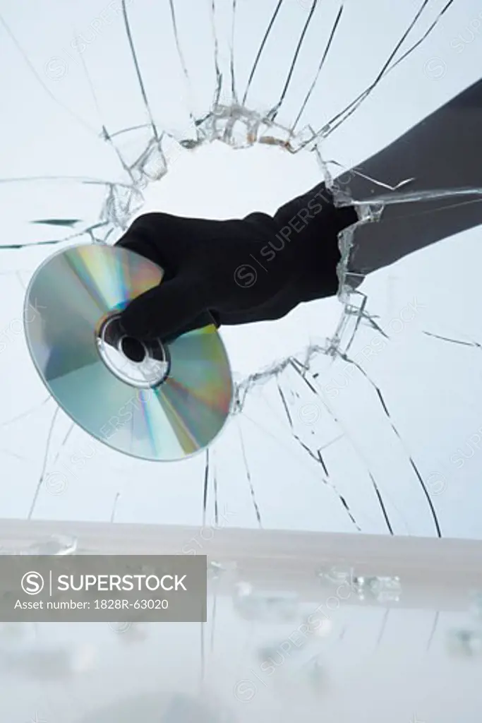 Hand Stealing CD Through Broken Glass